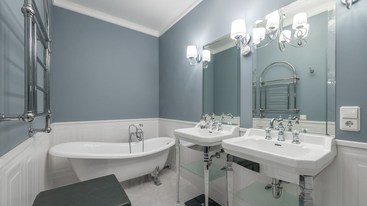 Salle de bain sans fenêtre éclairée par des appliques au-dessus du miroir